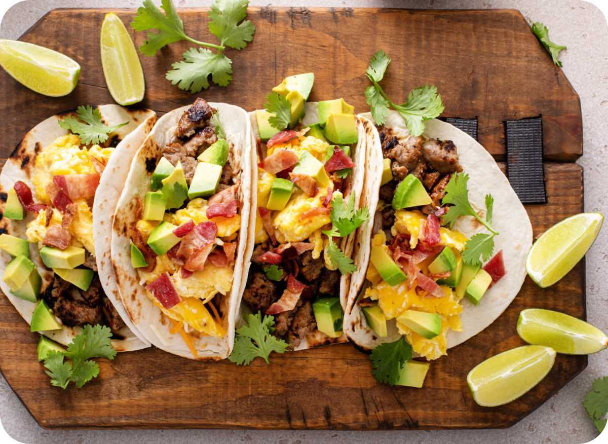 Tacos topped with avocado and cilantro
