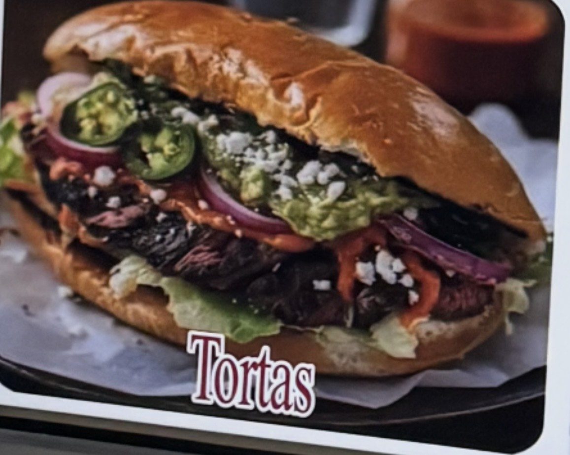 Delicious torta sandwich with fresh toppings and a soft bun.